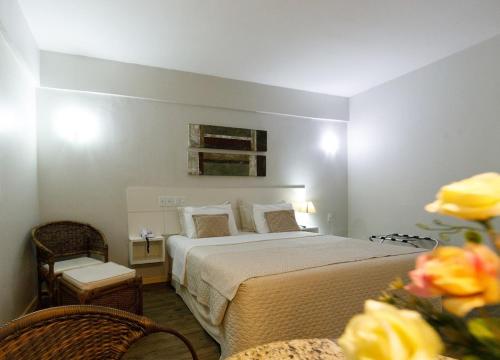 Ein Bett oder Betten in einem Zimmer der Unterkunft Tarik Fontes Plaza Hotel