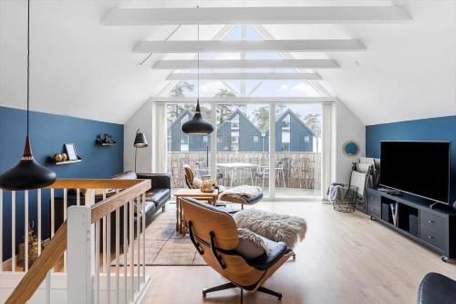 a living room with blue walls and a large window at M361-Vaeggerlose-Marielyst-Strandvej-63-U in Marielyst