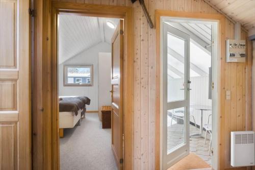 a room with a bed and a door to a bedroom at M365-Gedser-Lollandsvej-9 in Gedser