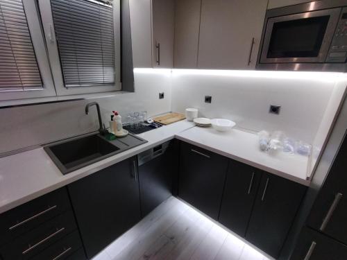 a small kitchen with a sink and a counter at При митака in Pernik