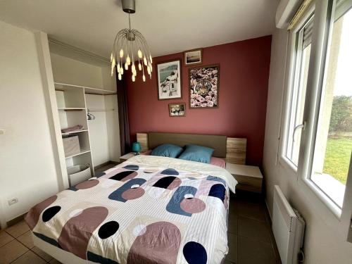 a bedroom with a bed with a hello kitty comforter at Le Pavillon - Ideal CNPE et découverte de la Touraine in Chinon