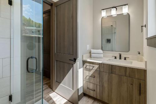 a bathroom with a sink and a glass shower at Romantic 1BR Getaway Across from Purgatory Resort in Durango Mountain Resort