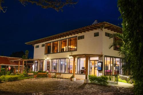 a building with a lot of windows at night at Hotel Posada de Don Rodrigo Panajachel in Panajachel