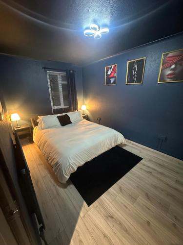 a bedroom with a bed and a ceiling fan at Adult only, fetish retreat play space in Ifield