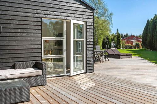 a wooden deck with a sliding glass door on a house at M379-Vaeggerlose-Baeverstien-43 in Marielyst