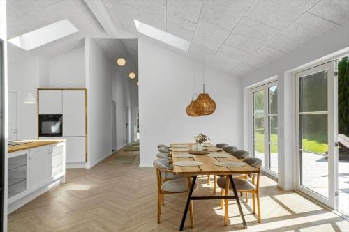 a kitchen and dining room with a table and chairs at M379-Vaeggerlose-Baeverstien-43 in Marielyst
