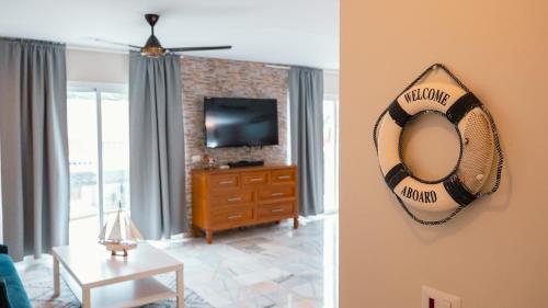 a living room with a mirror and a tv at Ka' Romana Residences in El Soco