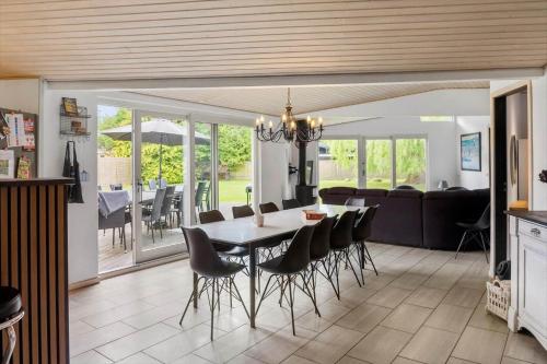 a dining room and living room with a table and chairs at M378-Vaeggerlose-Angelikvej-8 in Marielyst