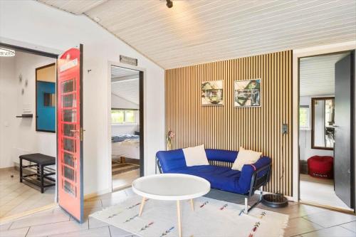 a living room with a blue couch and a table at M378-Vaeggerlose-Angelikvej-8 in Marielyst