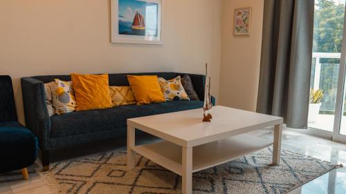 a living room with a couch and a table at Ka' Romana Residences in El Soco