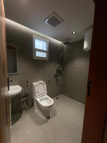a bathroom with a toilet and a sink at DownTown Suites OrbitNet RUH 4 in Riyadh