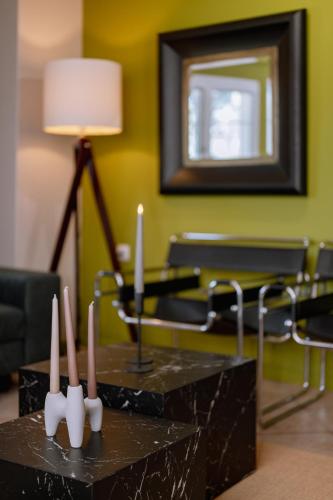 a living room with two tables with candles on them at Ikigai Eden in Kavála