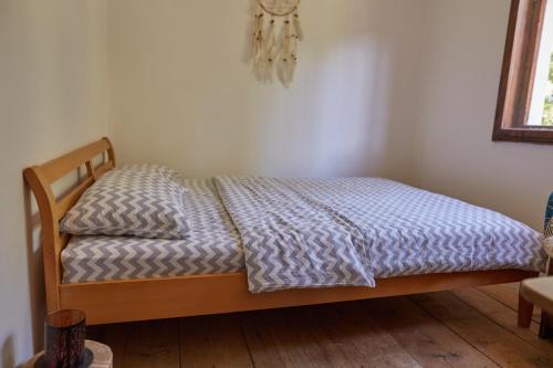 a bedroom with a bed with a blue comforter at Foreside Escape Montenegro in Žabljak