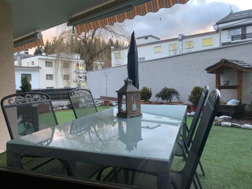 a table and chairs with a light on a patio at Charmant appartement, hyper central, à 2 min de tout, énorme terrasse privée et parking couvert in Crans-Montana