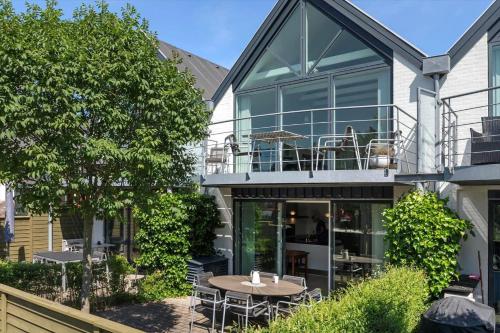 a house with a patio with a table and chairs at M384-Vaeggerlose-Marielyst-Strandvej-63-B in Marielyst