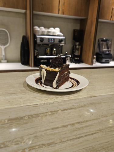 a piece of chocolate cake on a plate on a counter at Zesora Nathia Gali in Nathia Gali