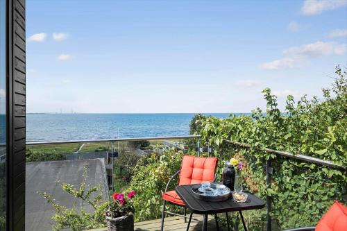 a balcony with a table and a view of the ocean at SL324-Slagelse-Strandvaenget-29 in Slagelse