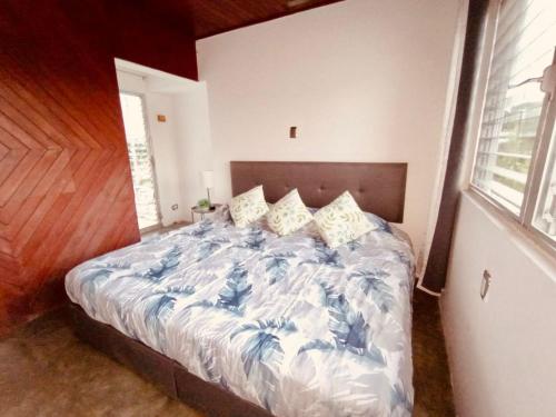 a bedroom with a bed with a blue comforter at Tuxpan AA 4Be 2B 2parking in Tuxpan de Rodríguez Cano