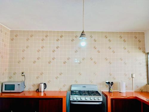 a kitchen with a stove and a microwave at Tuxpan AA 4Be 2B 2parking in Tuxpan de Rodríguez Cano
