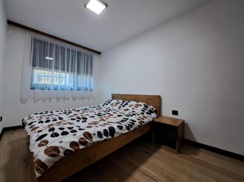 a bedroom with a bed with shoes on it at Alpine Noir 2 in Bjelašnica