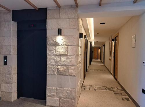 a hallway of a building with a blue wall at Alpine Noir 2 in Bjelašnica