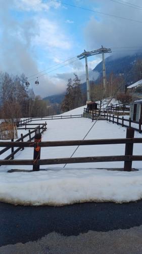 a fence with snow on it next to a ski lift at Pila Petit Coin Gerdaz Les Fleurs SKI & MTB in Cerise