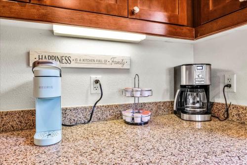 a kitchen counter with a coffee maker on the counter at Spectacular Desert Retreat in La Quinta #A in La Quinta