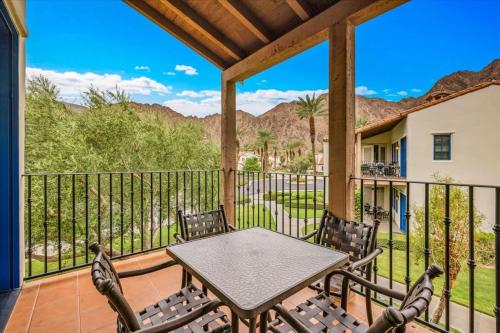 a patio with a table and chairs on a balcony at Spectacular Desert Retreat in La Quinta #A in La Quinta