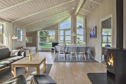 a living room with a table and a fireplace at SL265-Korsor-Havstokken-1 in Korsør