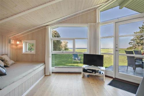 a room with a bed and a desk with a television at SL265-Korsor-Havstokken-1 in Korsør