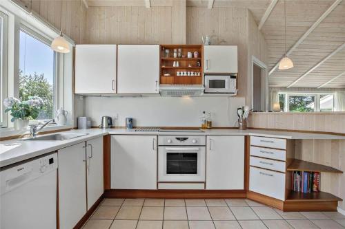 a kitchen with white cabinets and a sink at SL265-Korsor-Havstokken-1 in Korsør