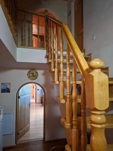 a hallway with a wooden stairway leading to a door at EkoTurystyka Natura Gwiazd - Green Velo - Workation Park - Ziołowy Klimat Bieszczad in Dubiecko