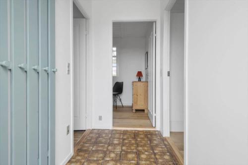an empty hallway with white walls and a carpet at SL320-Slagelse-Kongsmarkvej-6 in Slagelse