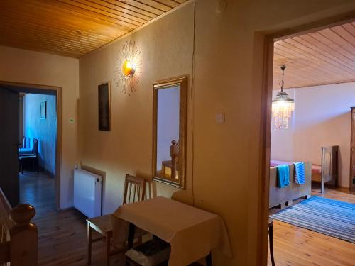 a living room with a table and a mirror at EkoTurystyka Natura Gwiazd - Green Velo - Workation Park - Ziołowy Klimat Bieszczad in Dubiecko