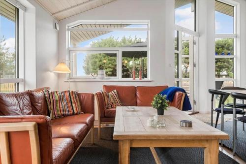 a living room with a couch and a table at SL328-Slagelse-Egebaekvej-21 in Slagelse