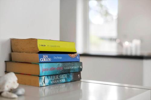 a stack of books sitting on top of a table at SL328-Slagelse-Egebaekvej-21 in Slagelse