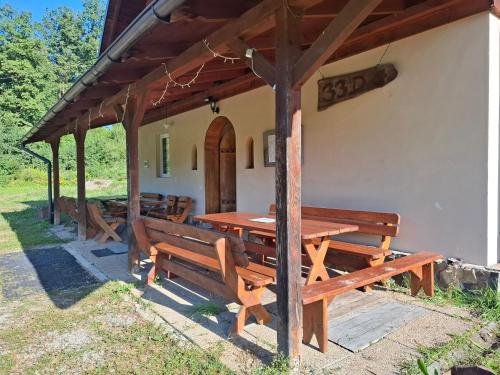 a picnic table and benches in front of a building at EkoTurystyka Natura Gwiazd - Green Velo - Workation Park - Ziołowy Klimat Bieszczad in Dubiecko