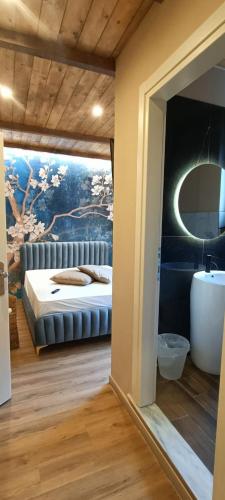 a bedroom with a bed with a painting on the wall at HOTEL ARIMANNIA Depandance in Caramanico Terme