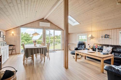 a living room with a table and a couch at SL221-Slagelse-Horvangen-2 in Slagelse
