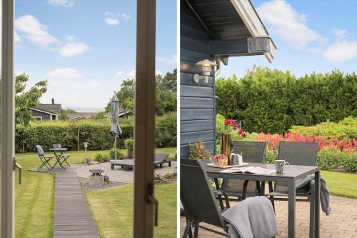 a patio and backyard with a table and chairs at SL221-Slagelse-Horvangen-2 in Slagelse