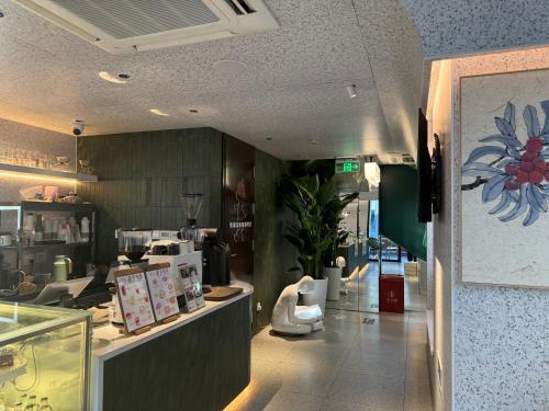 a restaurant with a kitchen with a counter and a counter at WeLight逐光旅舍百花深处胡同店 in Beijing