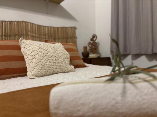 a bedroom with a bed with a pillow on it at Casa Cobogó in Cavalcante