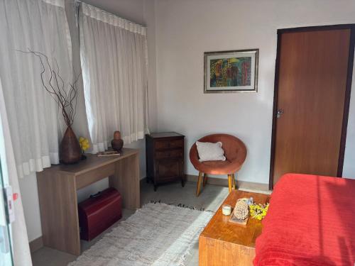 a bedroom with a bed and a chair and a table at Casa Cobogó in Cavalcante