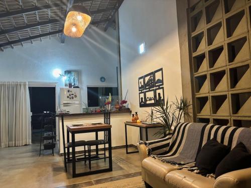 a living room with a couch and a table at Casa Cobogó in Cavalcante