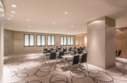 a large meeting room with tables and chairs at The Posthouse Berlin Potsdamer Platz- Leonardo Limited Edition in Berlin