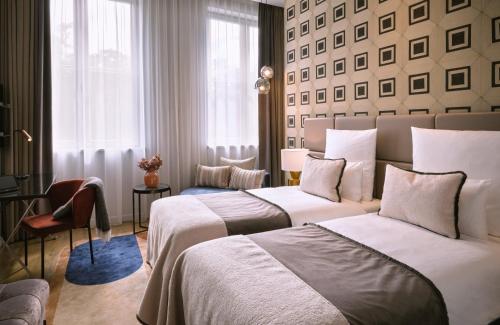 a hotel room with two beds and a window at The Posthouse Berlin Potsdamer Platz- Leonardo Limited Edition in Berlin