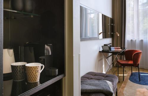 a living room with a table and a chair at The Posthouse Berlin Potsdamer Platz- Leonardo Limited Edition in Berlin