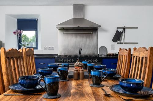 a wooden table in a kitchen with blue dishes on it at Charming Country house Getaway in Edenderry