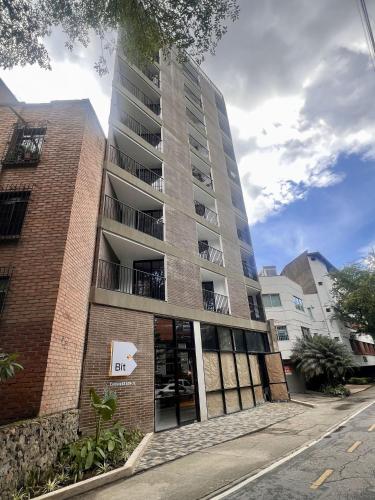 a tall brick building with a sign on it at BIT by Simple stay in Medellín