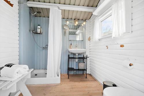 a bathroom with a sink and a toilet and a shower at SL243-Skaelskor-Hybenvej-30 in Skælskør